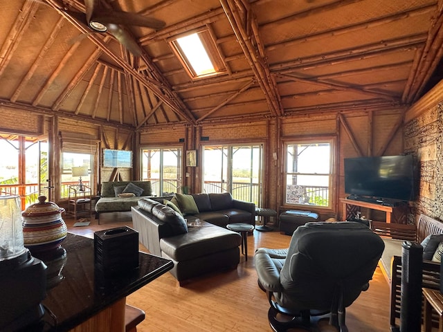 living room with lofted ceiling, hardwood / wood-style floors, and wooden walls