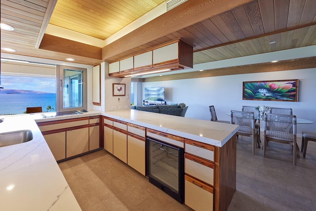 4000 Wailea Alanui Dr Unit 3003, Kihei, HI 96753 - kitchen with wood ceiling, a peninsula, recessed lighting, light tile patterned flooring, and wine cooler