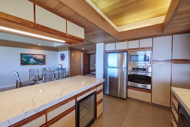 4000 Wailea Alanui Dr Unit 3003, Kihei, HI 96753 - kitchen with appliances with stainless steel finishes, wine cooler, a wood ceiling with exposed beams, white cabinetry, and light tile patterned floors