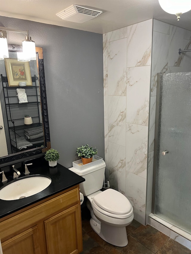 bathroom with vanity, toilet, and an enclosed shower