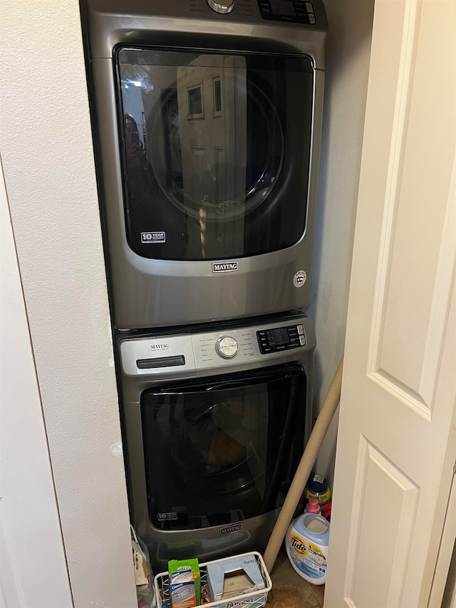 laundry area featuring stacked washing maching and dryer