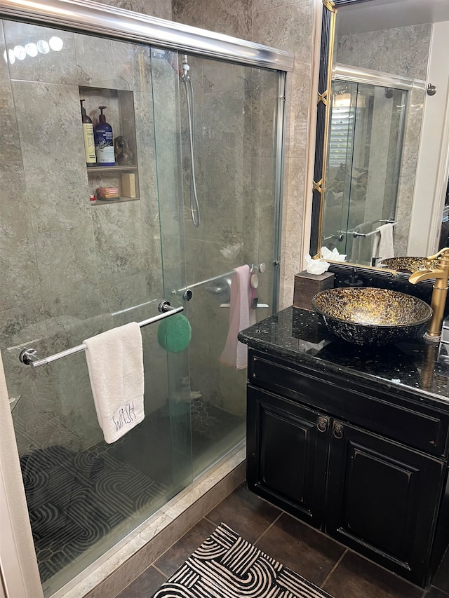 bathroom with tile patterned floors, walk in shower, and vanity