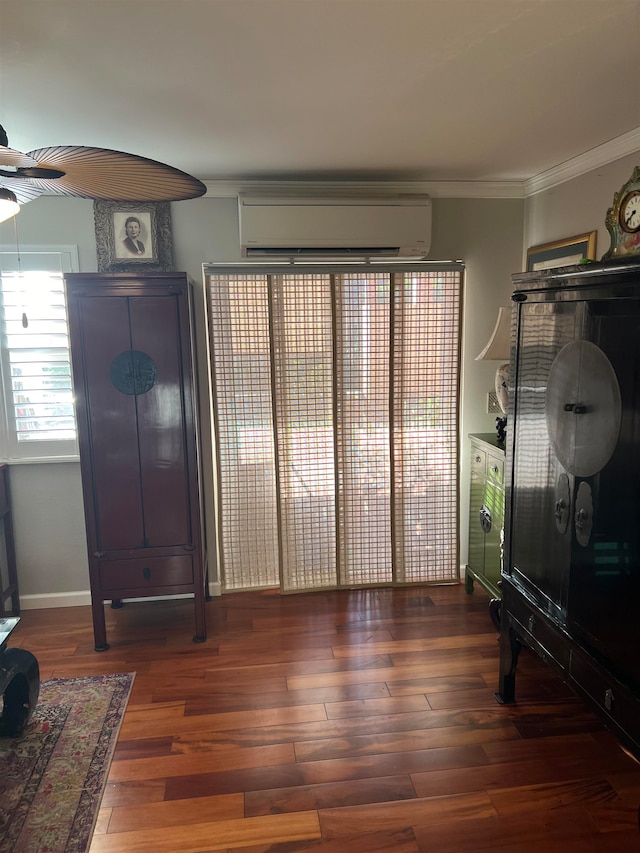 interior space with ceiling fan, crown molding, dark wood-type flooring, and a wall unit AC