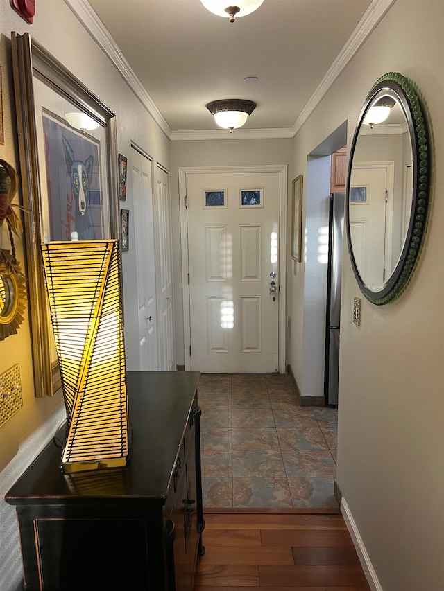 foyer featuring ornamental molding and dark hardwood / wood-style flooring