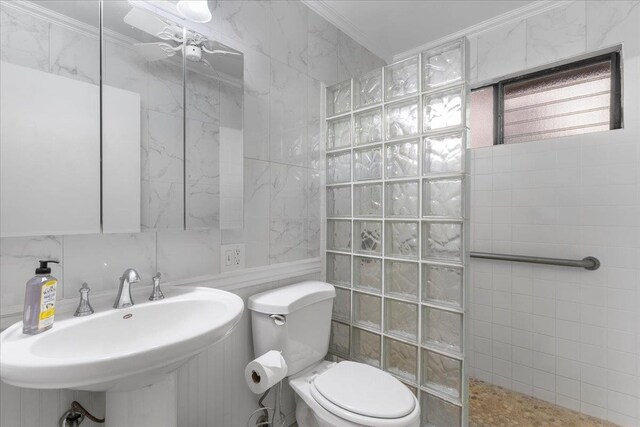 bathroom with toilet, walk in shower, ornamental molding, and tile walls