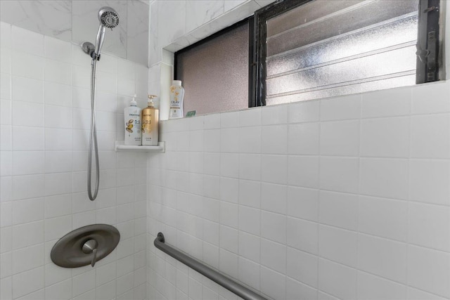 bathroom with a tile shower