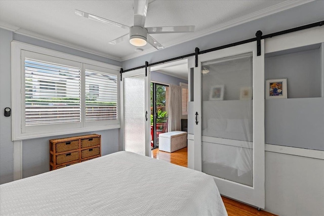 bedroom with light hardwood / wood-style floors, ceiling fan, and crown molding