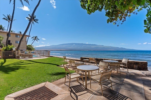 view of patio / terrace with a water and mountain view and a swimming pool