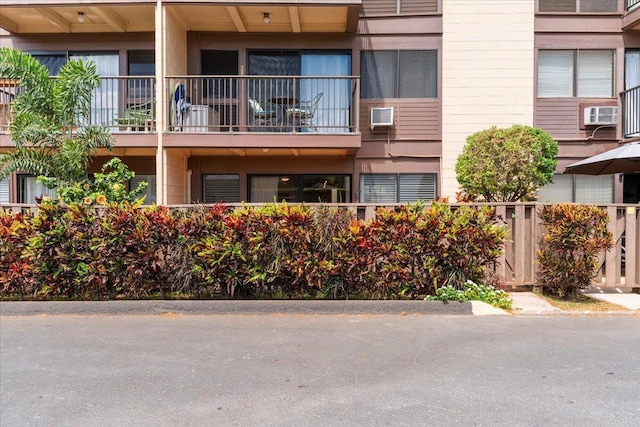 view of property with an AC wall unit