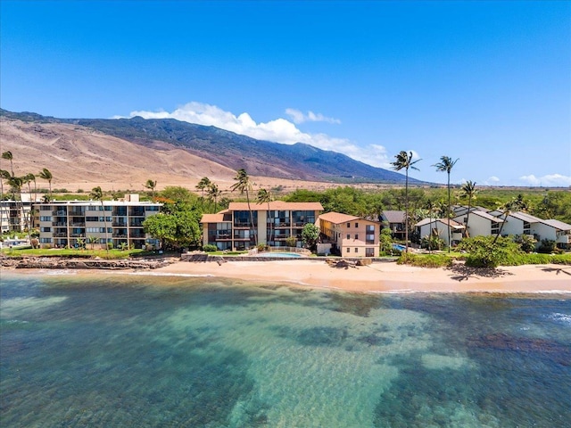 exterior space with a view of the beach and a water and mountain view