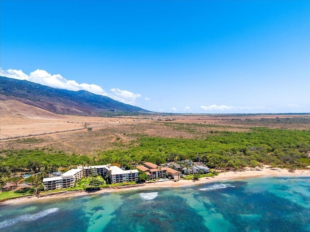 birds eye view of property featuring a view of the beach and a water and mountain view