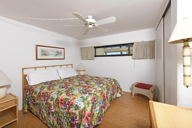 bedroom featuring ceiling fan, a closet, and wood-type flooring