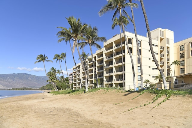 view of building exterior featuring a water and mountain view