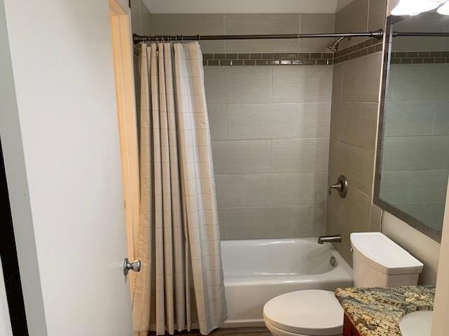 full bathroom with vanity, shower / bath combination with curtain, and toilet