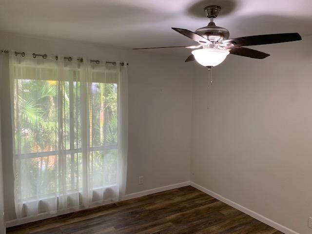 empty room featuring dark hardwood / wood-style flooring and ceiling fan