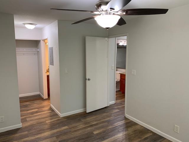 unfurnished bedroom featuring dark hardwood / wood-style flooring, a closet, and ceiling fan