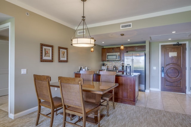 dining room featuring ornamental molding and light tile patterned floors