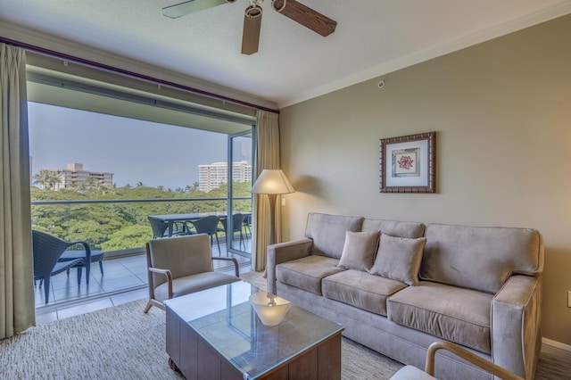 living room with ornamental molding, ceiling fan, and light tile patterned floors