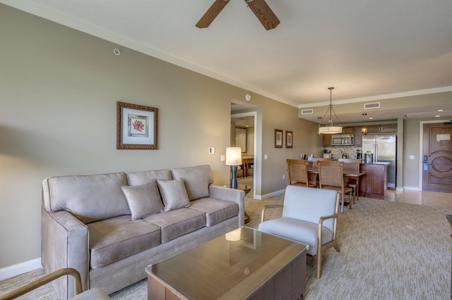 living room featuring ceiling fan and ornamental molding