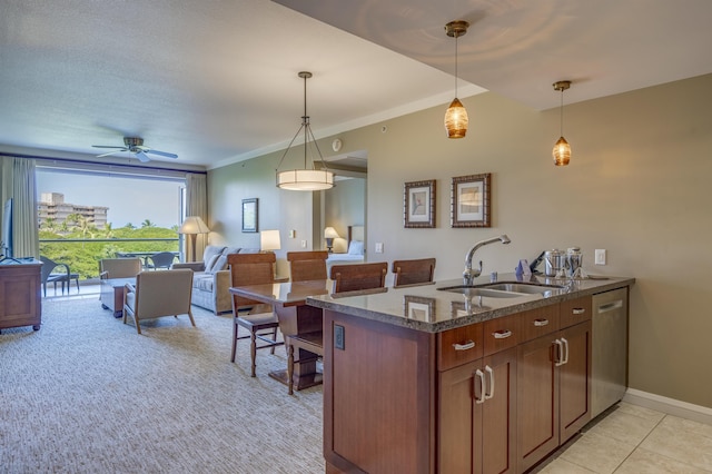 kitchen with stainless steel dishwasher, sink, pendant lighting, and kitchen peninsula