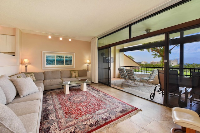 tiled living room with rail lighting and a textured ceiling