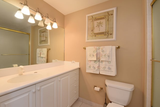 bathroom featuring tile flooring, toilet, and vanity