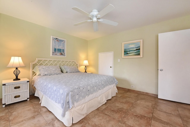 tiled bedroom featuring ceiling fan