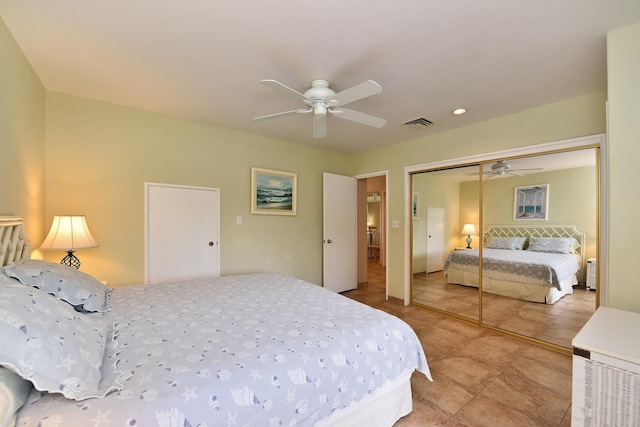 bedroom featuring a closet, ceiling fan, and light tile flooring