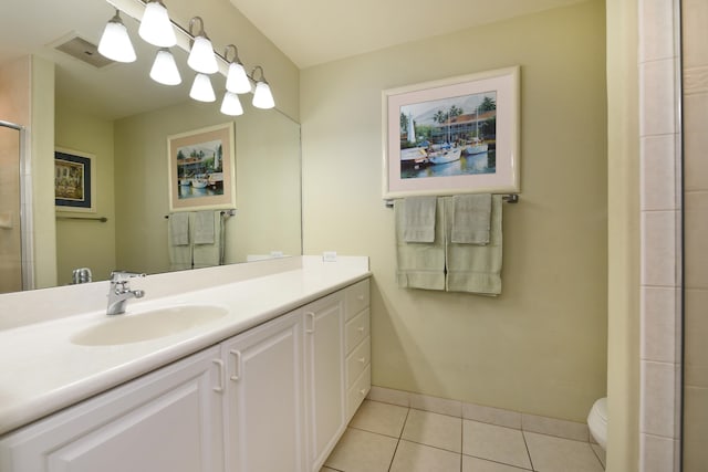 bathroom featuring tile floors, toilet, and vanity