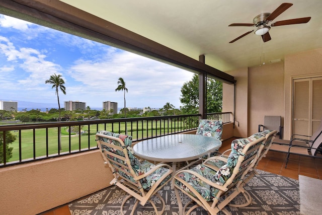 view of patio featuring a balcony and ceiling fan