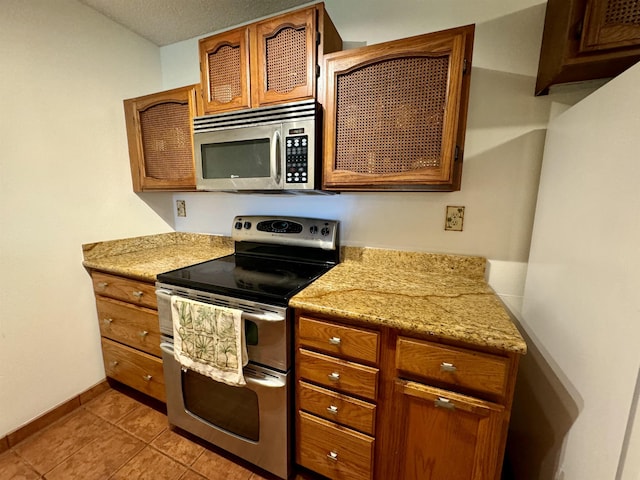 50 Kepuhi Pl Unit 103, Maunaloa, HI 96770 - kitchen with appliances with stainless steel finishes, light countertops, and brown cabinets