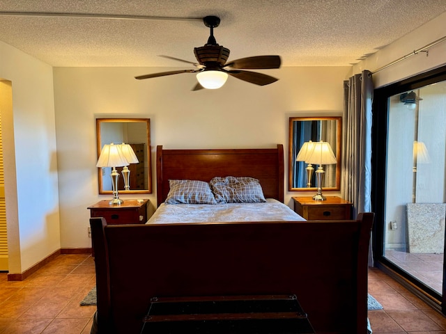 tiled bedroom featuring ceiling fan and a textured ceiling