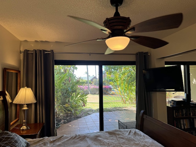 50 Kepuhi Pl Unit 103, Maunaloa, HI 96770 - bedroom featuring access to outside, a textured ceiling, tile patterned floors, and ceiling fan