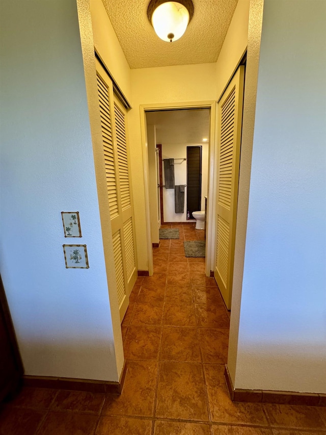 50 Kepuhi Pl Unit 103, Maunaloa, HI 96770 - corridor featuring a textured ceiling and tile patterned floors