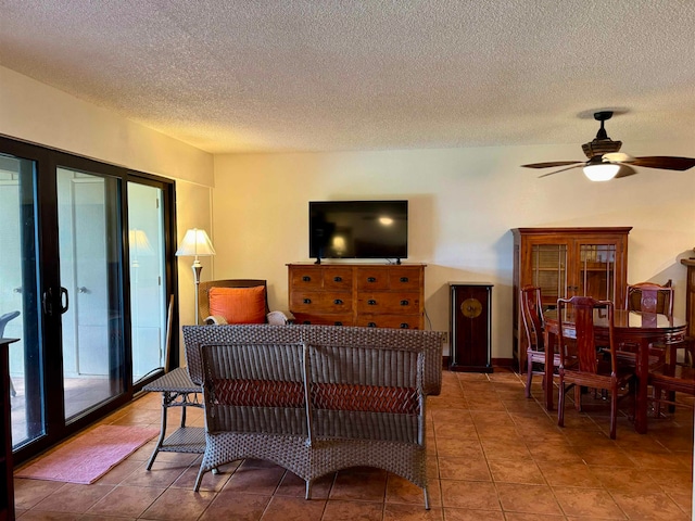 living room with tile patterned flooring, a textured ceiling, and ceiling fan