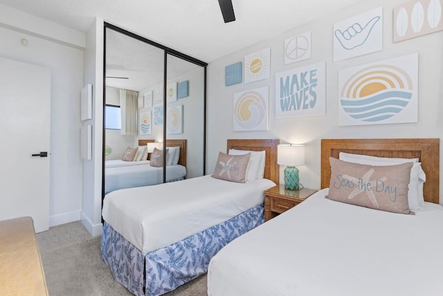 bedroom featuring ceiling fan, a closet, and carpet floors