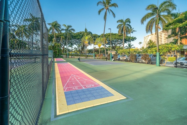 view of property's community featuring tennis court