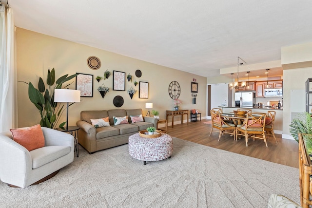 living room featuring dark wood-type flooring and a notable chandelier