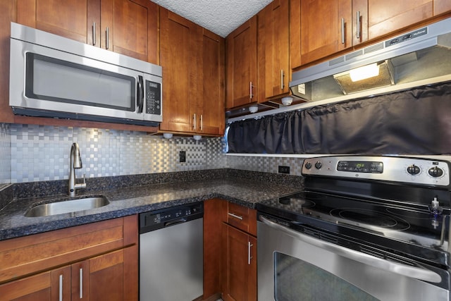 3676 Lower Honoapiilani Rd Unit G302, Lahaina, HI 96761 - kitchen featuring stainless steel appliances, under cabinet range hood, decorative backsplash, dark stone counters, and brown cabinetry