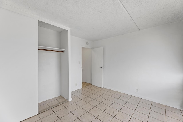 3676 Lower Honoapiilani Rd Unit G302, Lahaina, HI 96761 - unfurnished bedroom featuring a closet, a textured ceiling, and light tile patterned floors