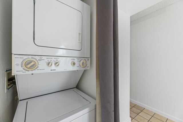 3676 Lower Honoapiilani Rd Unit G302, Lahaina, HI 96761 - laundry room with stacked washer and clothes dryer and light tile patterned floors