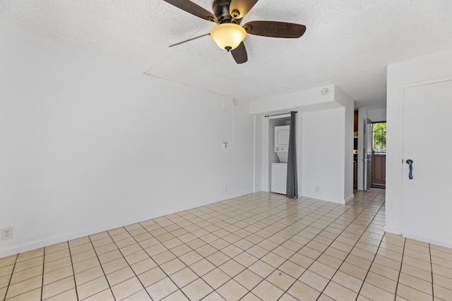 3676 Lower Honoapiilani Rd Unit G302, Lahaina, HI 96761 - unfurnished room featuring stacked washer and clothes dryer, a ceiling fan, a textured ceiling, and light tile patterned floors