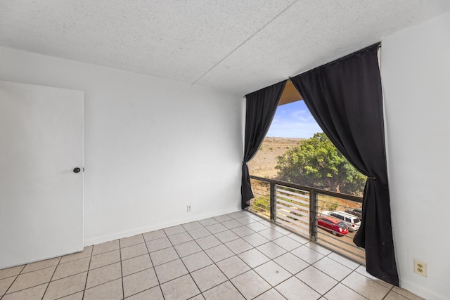 3676 Lower Honoapiilani Rd Unit G302, Lahaina, HI 96761 - empty room featuring a textured ceiling and light tile patterned flooring