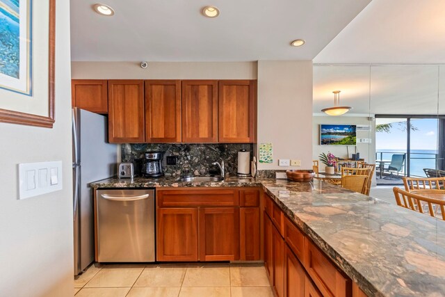 110 Kaanapali Shores Pl Unit 308, Lahaina, HI 96761 - kitchen with dishwasher, brown cabinetry, dark stone countertops, decorative backsplash, and recessed lighting