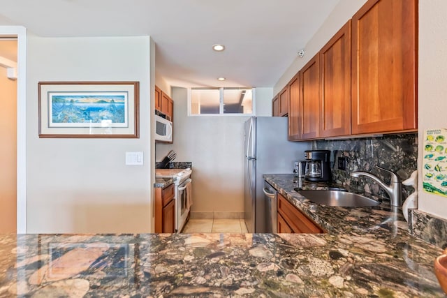 110 Kaanapali Shores Pl Unit 308, Lahaina, HI 96761 - kitchen featuring white appliances, brown cabinets, dark stone countertops, a sink, and recessed lighting