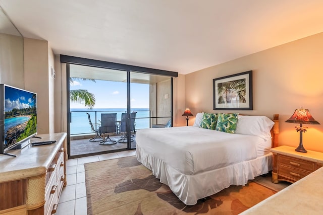 110 Kaanapali Shores Pl Unit 308, Lahaina, HI 96761 - bedroom with access to outside, a water view, and light tile patterned floors