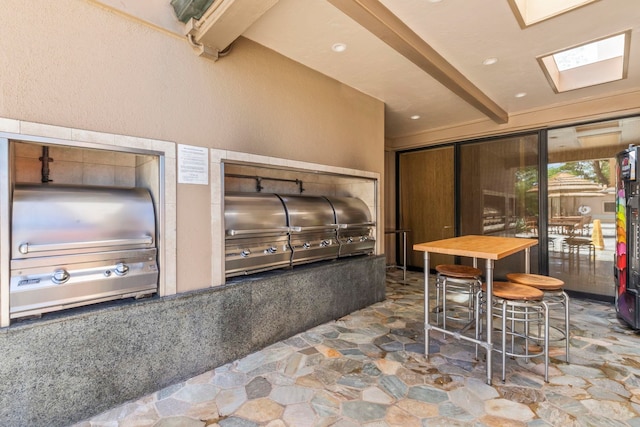 110 Kaanapali Shores Pl Unit 308, Lahaina, HI 96761 - kitchen featuring stone floors and a skylight