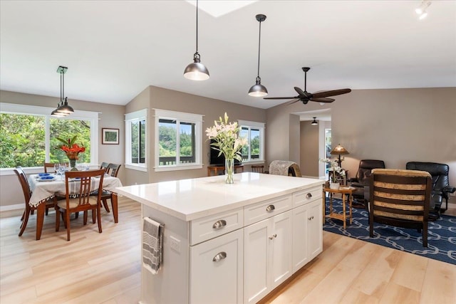 kitchen featuring a center island, pendant lighting, and light hardwood / wood-style flooring