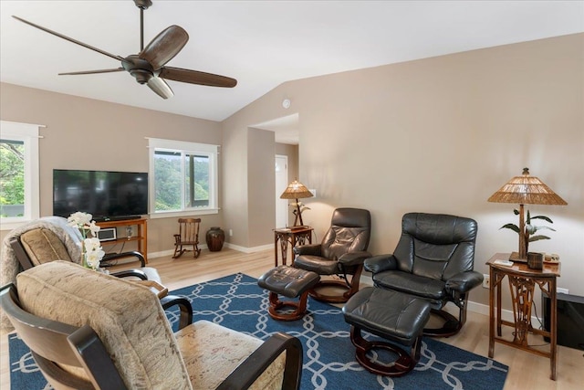 living room featuring vaulted ceiling, light hardwood / wood-style flooring, a healthy amount of sunlight, and ceiling fan