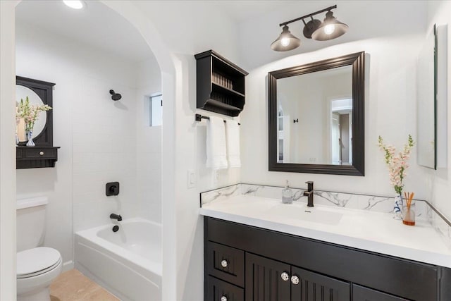 full bathroom with tile flooring, vanity with extensive cabinet space, tiled shower / bath combo, and toilet